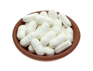 Fototapeta na wymiar L-lysine tablets in shallow dish