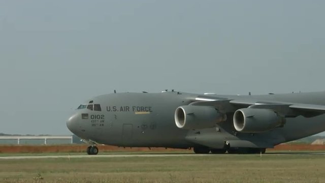 Close view of Boeing C-17 Globemaster military transport taxiing at airfield. Used by the United States Air Force and developed by McDonnell Douglas.  Recorded in 4K, ultra high definition.
