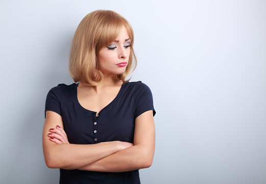 Resentful unhappy casual woman with short blond hair looking dow