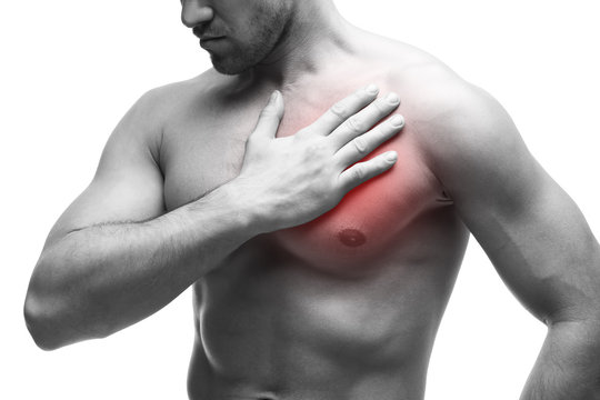 Heart attack. Young muscular man with chest pain isolated on white background