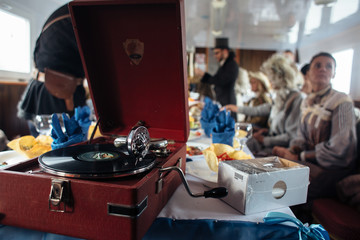 Turntable playing vinyl with background history people party