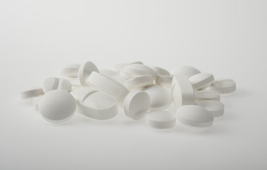 Medicine pills or capsules on white background.