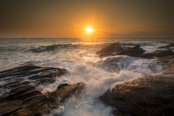 sea waves lash line impact rock on the beach