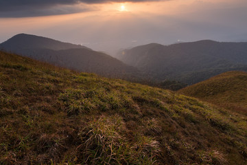 Fototapeta na wymiar beautiful sunset on the mountain with green field at doi monjong