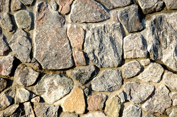A small section of the wall, made of raw granite.