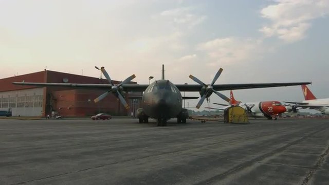 Tilt from tarmac to wide view of Transall C-160 military transport plane, developed by France and Germany, parked at airfield in USA.  Recorded in 4K, ultra high definition.