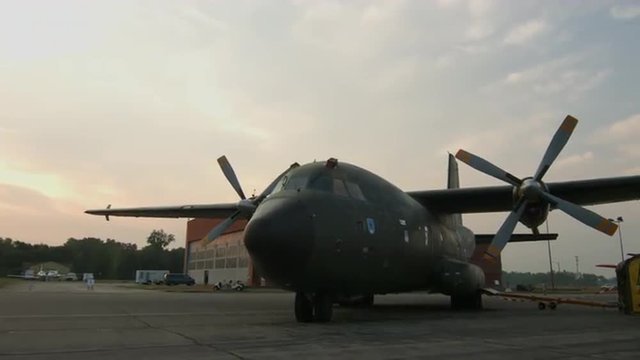 Tilt down from dawn sky to Transall C-160 military transport plane, developed by France and Germany, parked at airfield in USA.  Recorded in 4K, ultra high definition.