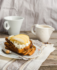 toast for breakfast with sweet cream cheese and pear, a cup of c