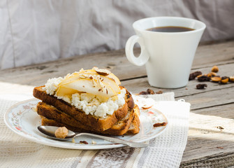toast for breakfast with sweet cream cheese and pear, a cup of c