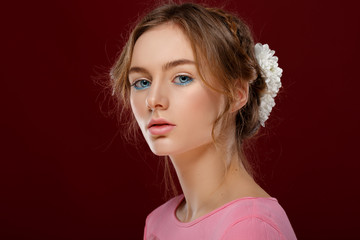 Pretty young girl in a pink dress, sweet and sensual. Blue eyes. flowers in the hair