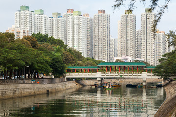 Fototapeta premium View of a river, bridge and residential buildings in Tai Po New Town, Hong Kong, China.