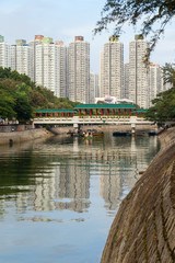 View of a river, bridge and residential buildings in Tai Po New Town, Hong Kong, China.