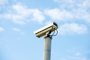 Security or cctv camera on blue sky background.
