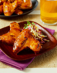 Chicken Wings on Plate with Beer in Background