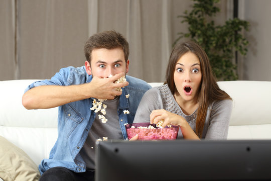 Amazed Couple Watching Tv