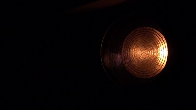 In Dark Studio The Searchlight with Fresnel's Lens Dies Away Slowly