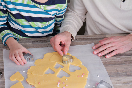 St. Valentine's Day Cookies. Father And Child Making Heart Shaped Cookies Close Up. Surprise Present Ideas For Mother Birthday Or Mother's Day. Family Concept. Baking With Kids