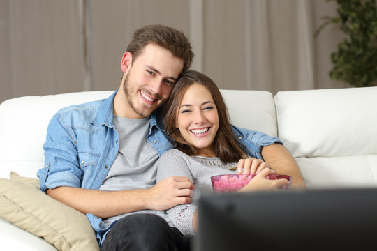 Happy Couple Watching Movie On Tv