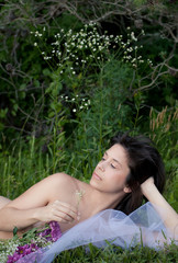 Obraz na płótnie Canvas Nude Woman Lying in Grass