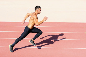 Sprinter leaving  on the running track.