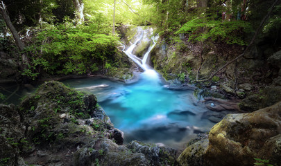 Obraz premium Majestic nature background of mountain river stream and small blue water lake in wild tropical forest