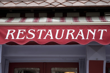 Restuarant Sign on Red Blind over Restaurant