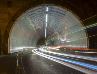 car lights in a tunnel, city at night.