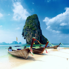 Tropical island landscape background. Thailand beach and wooden boats