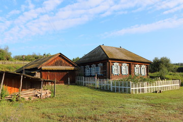 Very old wooden house in the remote Russian village in the summer against a blue sky