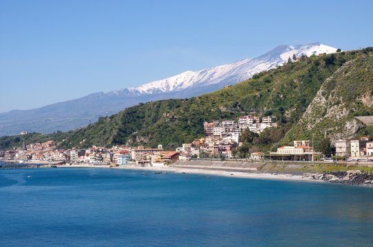 The bay of Giardini Naxos and volcano Etna from Taormina, Sicily, Italy