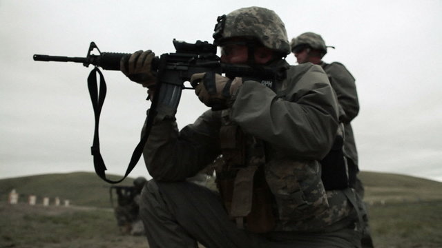 Kneeling Green Beret shooting M4