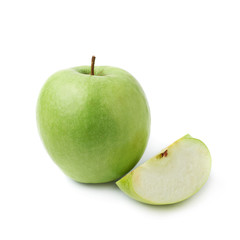 Green apple next to a slice isolated