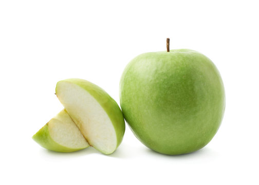 Green apple next to a slice isolated