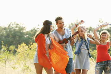 Fototapeta premium Joyful smiling friends dancing in the forest outdoors