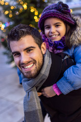 Happy father and daughter having fun in the street.