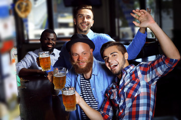 Young men drinking beer in pub