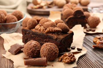 A piece of chocolate cake with walnut on the table, close-up