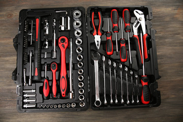 Tools in box on wooden background