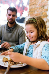 Fototapeta premium Happy young family having breakfast in the cafe.