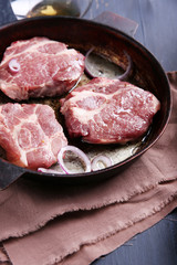 Marbled beef steak on pan and spices on color wooden background