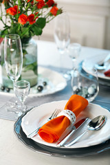 Served table with flowers in restaurant, closeup