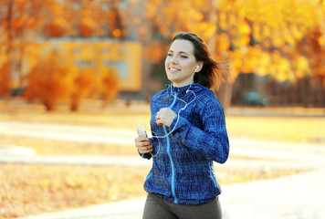 Fototapeta premium Young woman jogging at park
