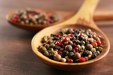 Pepper in wooden spoon on the table, close-up