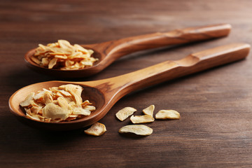 Two wooden spoons with almond flakes on the table, close-up
