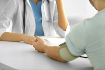 Doctor examining patient blood pressure