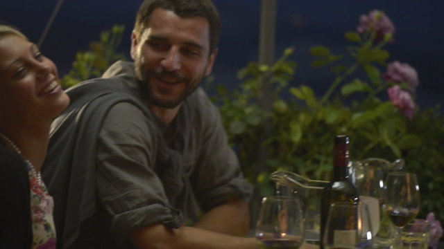 Friends in summer day evening are chattering at italian restaurant   