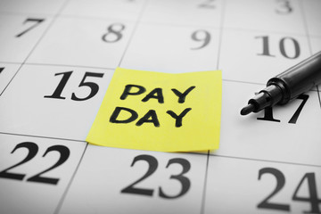 Payday concept. Calendar with black felt pen background, close up