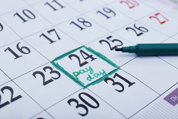 Payday concept. Calendar with green felt pen background. Date in frame, close up