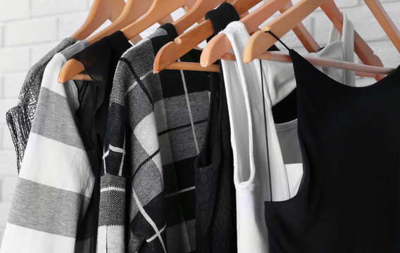 Collection of male and female clothes hanging on a rack