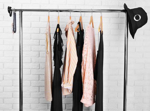 Collection of female clothes hanging on a rack